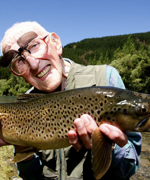Copyright 2008 MARTIN DE RUYTER/Nelson Mail. ALL THAT GLISTERS IS NOT OLD: Eric King-Turner, 103, with a glistening brown 
trout caught in the Motueka River with the guidance of Nelson Mail columnist Zane Mirfin.