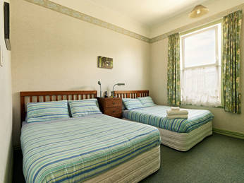 Photo of the double-glazed Green Room on the ground floor at the west side of Amber House showing the TWO Queen Beds 
so up to four can be accommodated with a delicious breakfast included in the price!